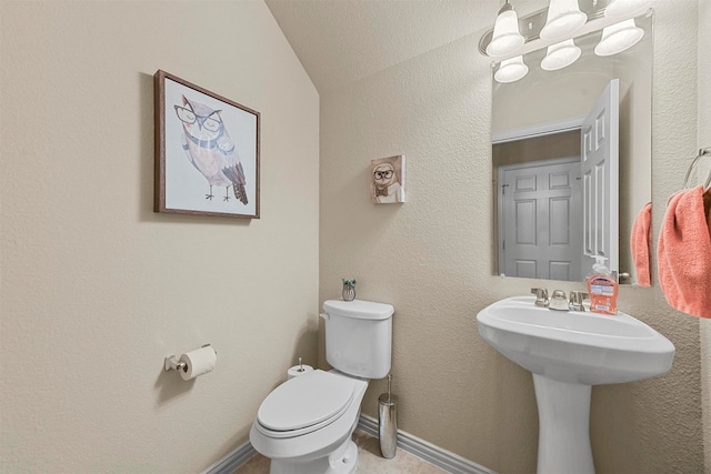 bathroom featuring vaulted ceiling and toilet