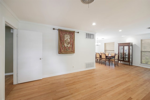 unfurnished room with ornamental molding and light hardwood / wood-style flooring