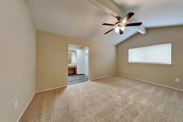 carpeted empty room with vaulted ceiling with beams and ceiling fan