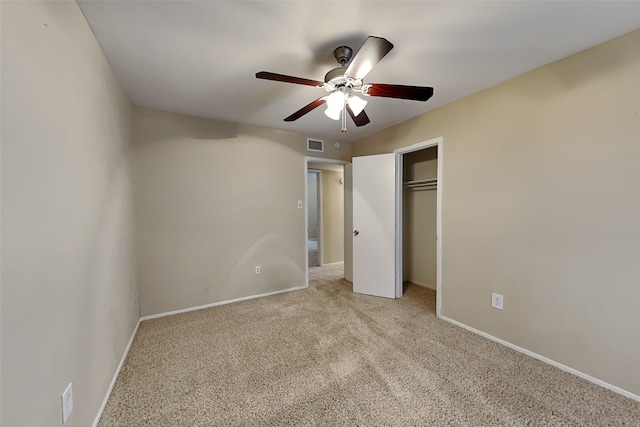 unfurnished bedroom with ceiling fan, a closet, and light carpet