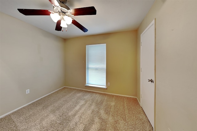 spare room featuring carpet flooring and ceiling fan