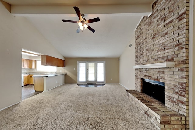 unfurnished living room featuring carpet, plenty of natural light, and beamed ceiling