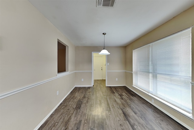 unfurnished dining area with wood-type flooring and plenty of natural light