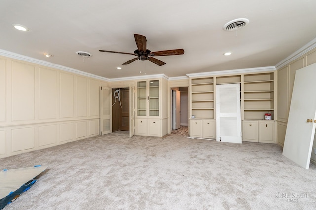 unfurnished bedroom with ceiling fan, ornamental molding, and light carpet