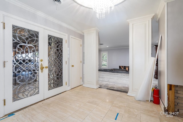 foyer entrance with light carpet, french doors, an inviting chandelier, and ornamental molding