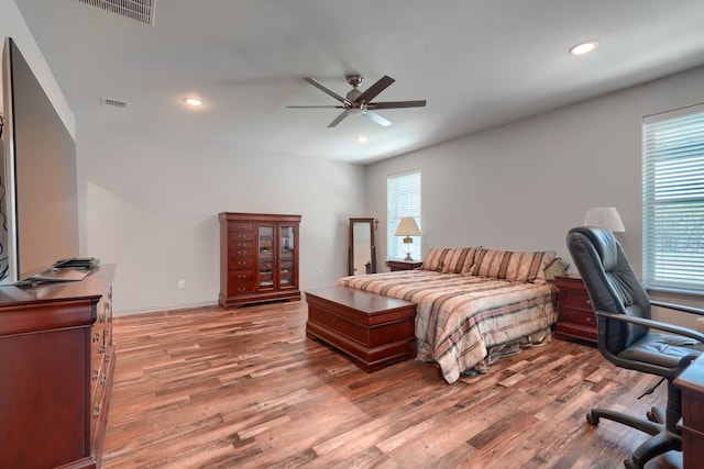 bedroom with ceiling fan and hardwood / wood-style floors