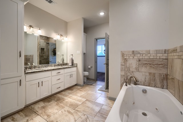 full bathroom featuring vanity, shower with separate bathtub, and toilet