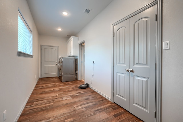 hall featuring washer / dryer and dark hardwood / wood-style floors