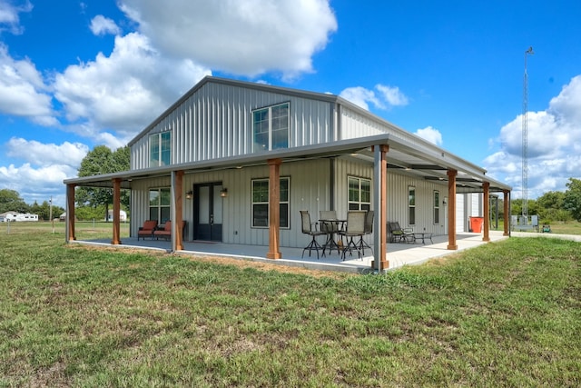 rear view of property featuring a patio and a lawn