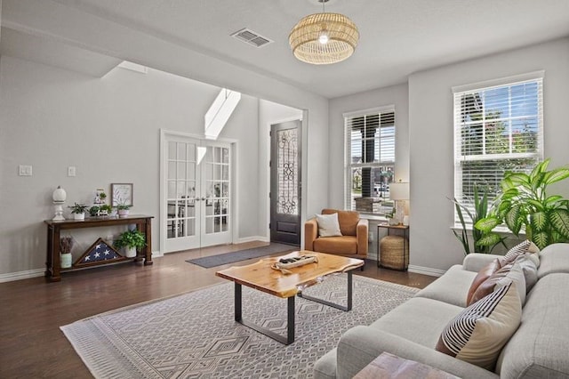 living room with french doors, an inviting chandelier, and dark hardwood / wood-style floors