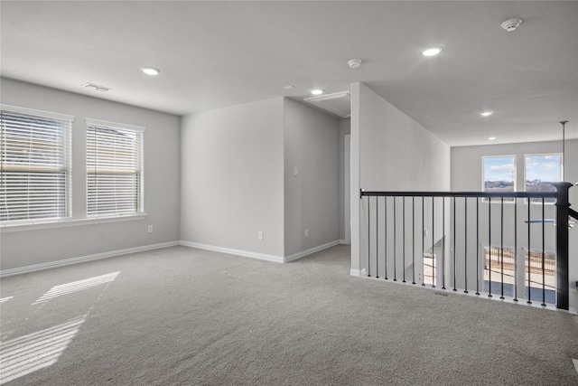 unfurnished room featuring light colored carpet