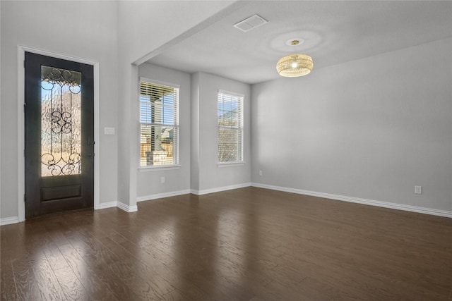 entryway with dark hardwood / wood-style flooring