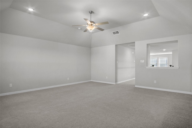 unfurnished room featuring ceiling fan, vaulted ceiling, and light carpet