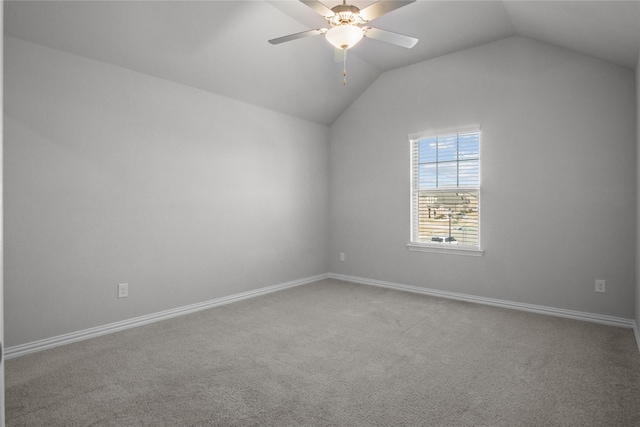 carpeted empty room featuring lofted ceiling and ceiling fan