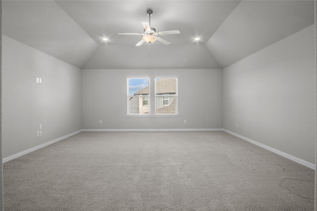 additional living space with vaulted ceiling, carpet, and ceiling fan