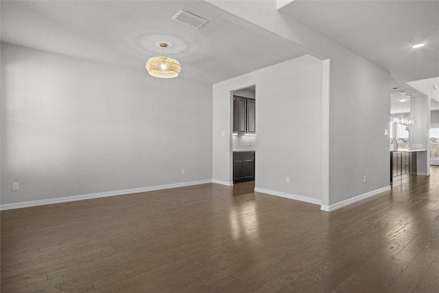 unfurnished room with dark wood-type flooring