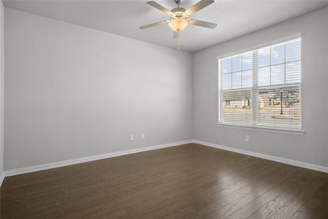 spare room featuring dark hardwood / wood-style floors and ceiling fan