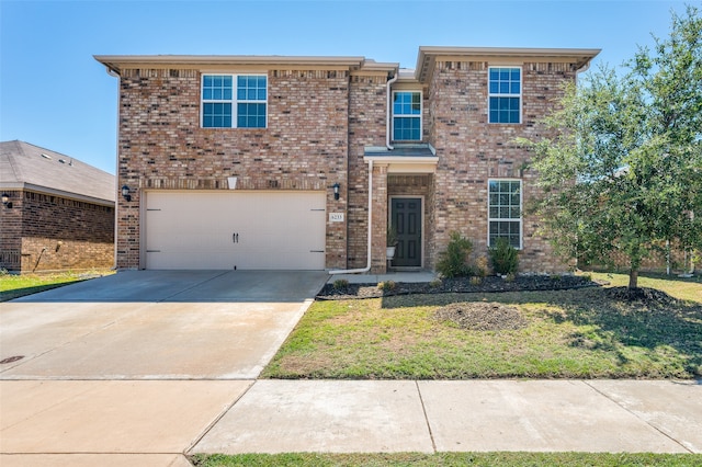 view of front of home featuring a garage and a front lawn