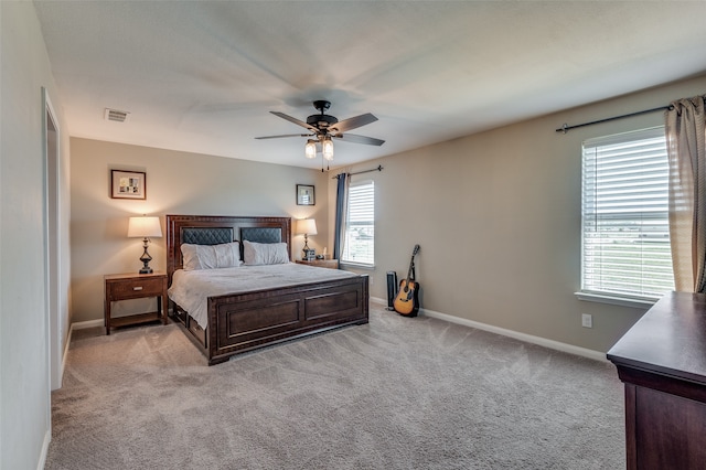 bedroom featuring light carpet and ceiling fan