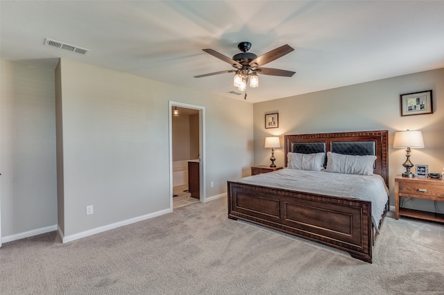 bedroom featuring light colored carpet, connected bathroom, and ceiling fan