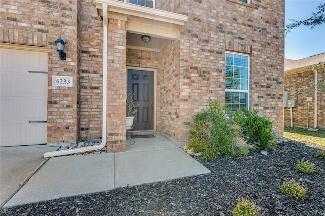 doorway to property with a garage