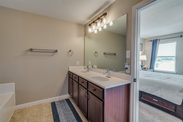 bathroom featuring vanity, a bath, and tile patterned floors