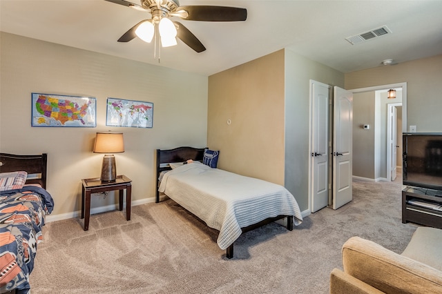 bedroom featuring light colored carpet and ceiling fan