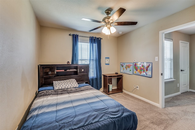 bedroom with light colored carpet and ceiling fan