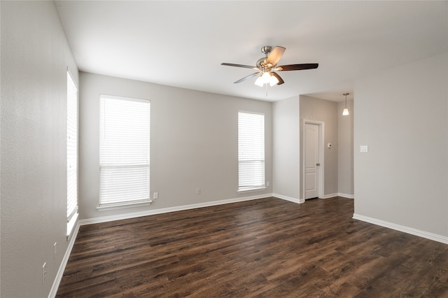 spare room featuring dark hardwood / wood-style floors, a healthy amount of sunlight, and ceiling fan