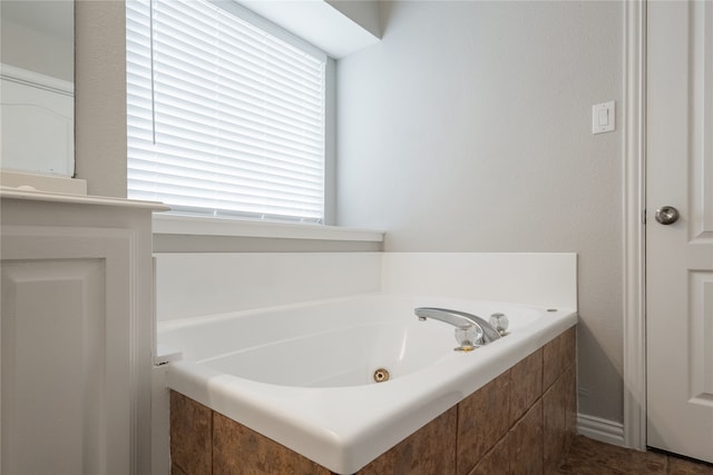 bathroom featuring a relaxing tiled tub