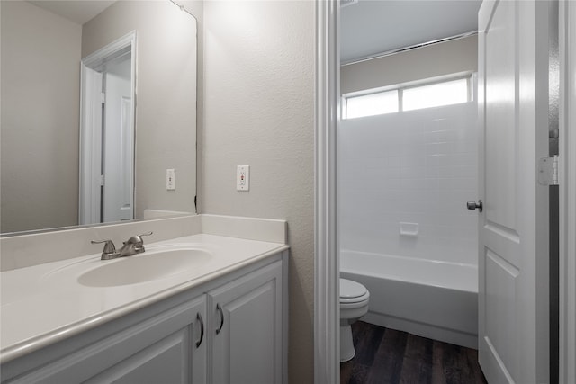 full bathroom featuring vanity, toilet, tub / shower combination, and hardwood / wood-style floors