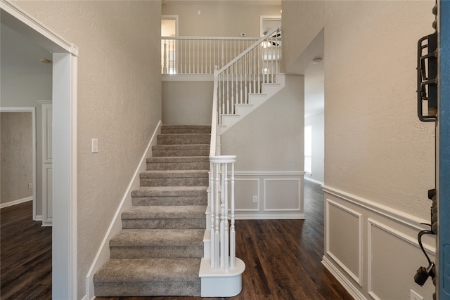 staircase featuring wood-type flooring