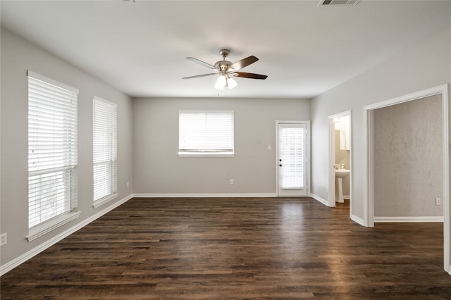 unfurnished room with sink, ceiling fan, and dark hardwood / wood-style flooring