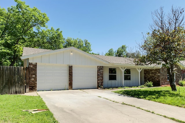 ranch-style home with a garage and a front lawn