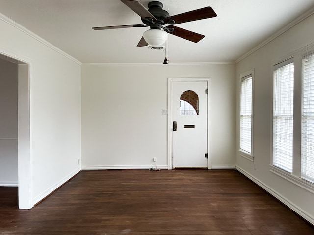 foyer entrance featuring ornamental molding, ceiling fan, and dark wood-type flooring