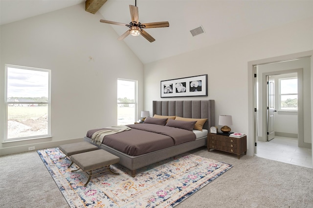 carpeted bedroom with multiple windows, beam ceiling, ceiling fan, and high vaulted ceiling