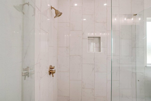 bathroom featuring vanity and a shower with shower door