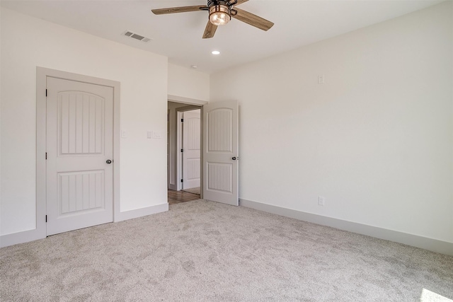 unfurnished bedroom featuring ceiling fan and light colored carpet