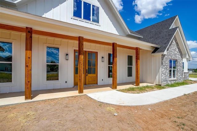 view of exterior entry with a porch