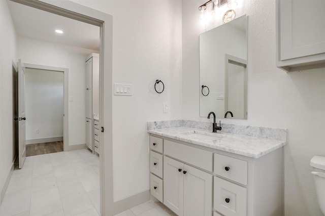 bathroom featuring vanity, toilet, and tile patterned floors