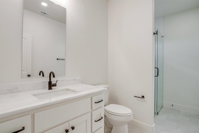 bathroom with tile patterned flooring, vanity, toilet, and a shower with shower door