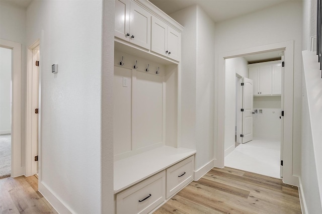 mudroom featuring light wood-type flooring and baseboards