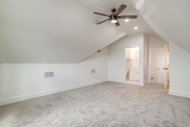 bonus room with lofted ceiling, light carpet, visible vents, and baseboards