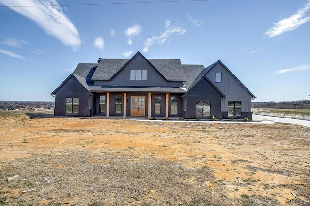 modern inspired farmhouse featuring board and batten siding and a shingled roof