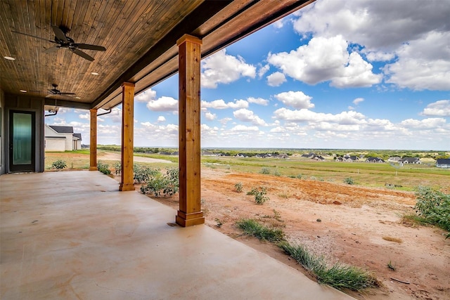 view of patio featuring a ceiling fan and a rural view