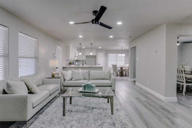 dining area with light wood-type flooring and ceiling fan