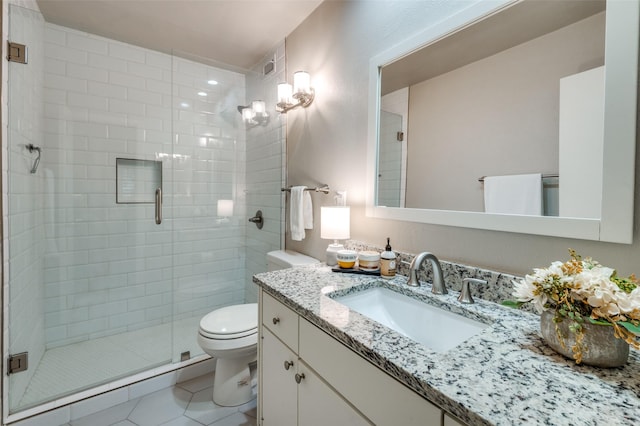 bathroom featuring an enclosed shower, vanity, tile patterned floors, and toilet