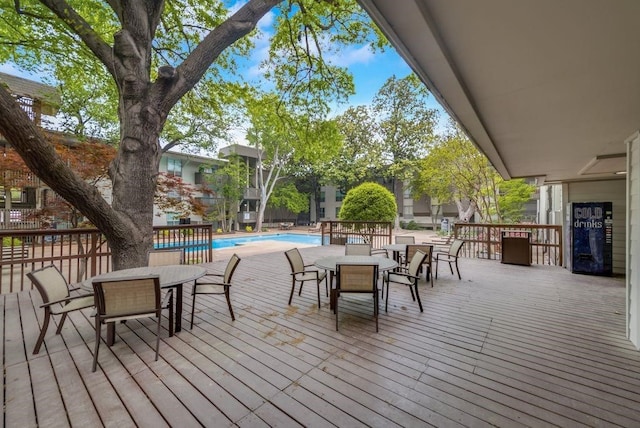 wooden deck with a community pool