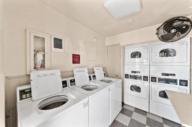 laundry area featuring stacked washer / dryer and washer and clothes dryer