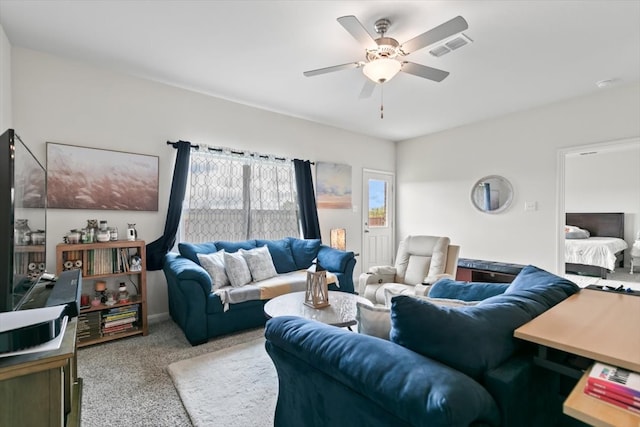 living room featuring ceiling fan and light colored carpet